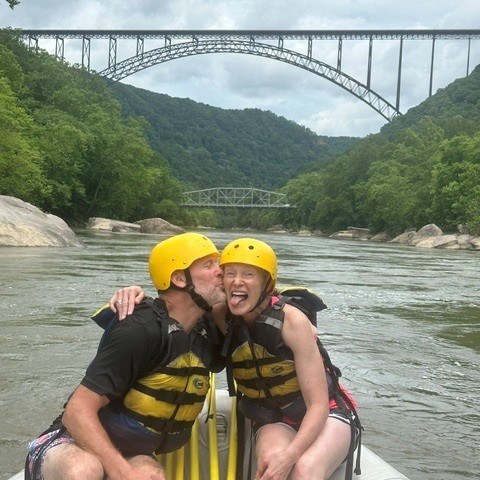 a person is crossing a bridge over a body of water