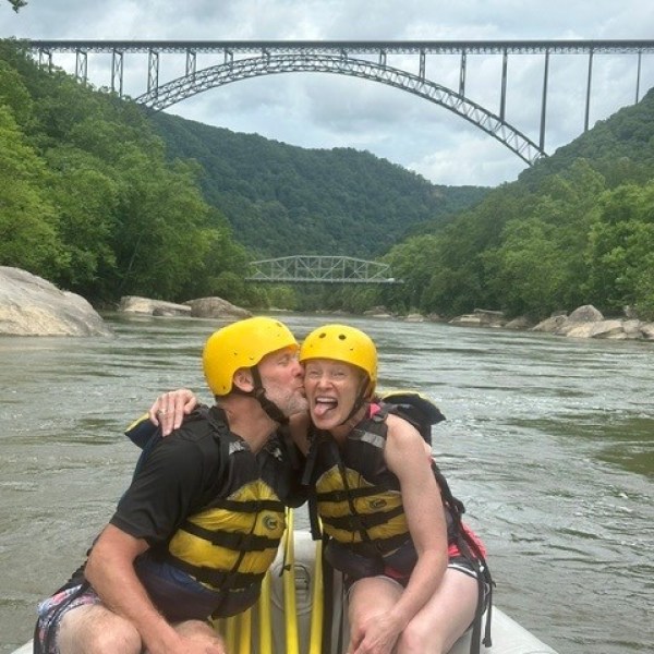 a person is crossing a bridge over a body of water